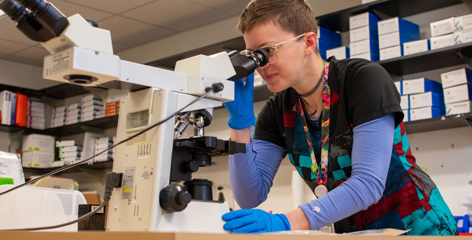 scientist looking into a microscope